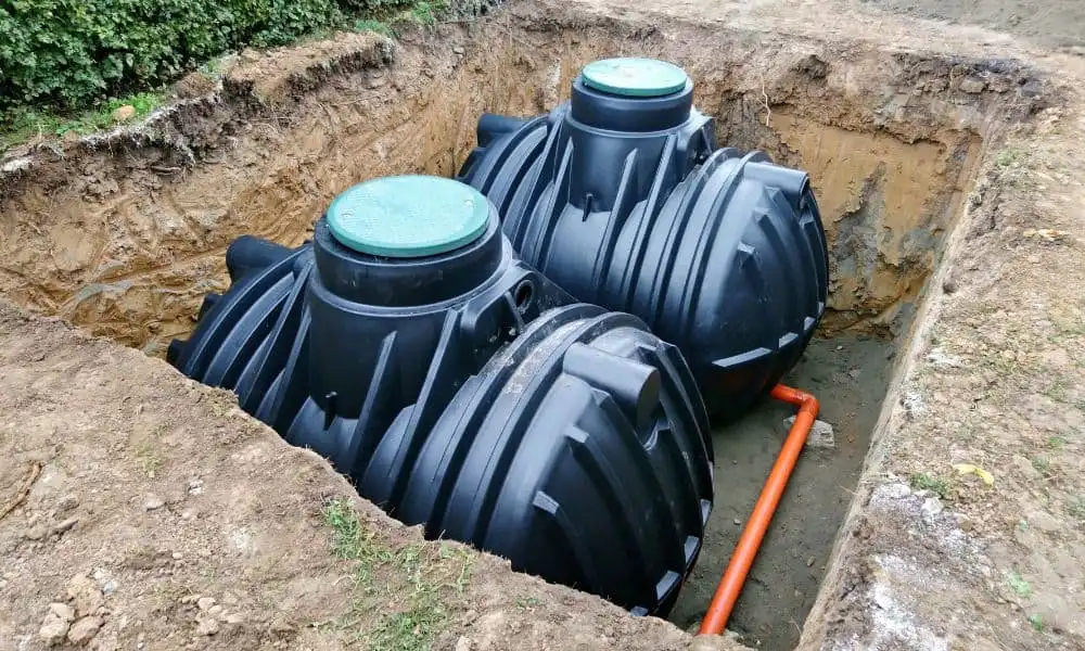 A new residential dual-tank septic system installation nested inside an excavated backyard pit, delivering full-scale plumbing Sapulpa waste management services