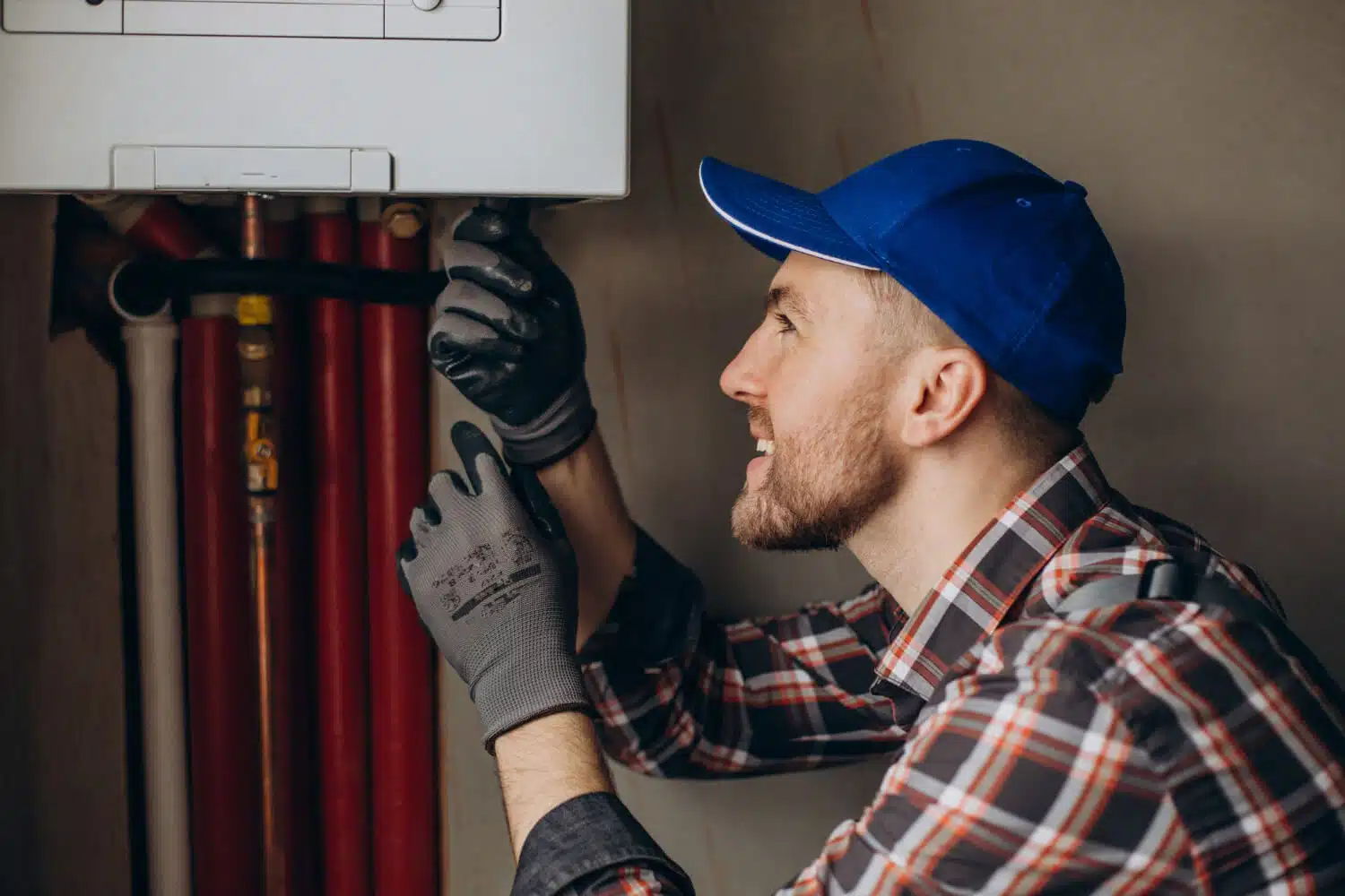 Tulsa Plumber Service Man Adjusting House Heating System 1